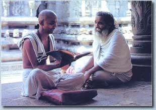 Two Brahamanas discuss the sastras in the Sounth Indian temple of Varaha-Nsimha Swami in Samhacalam. Through learning and saintly conduct the Brahmanas strive to preserve the best of India's great culture.  Image copyright: The Bhaktivedanta Book Trust--www.Krishna.com